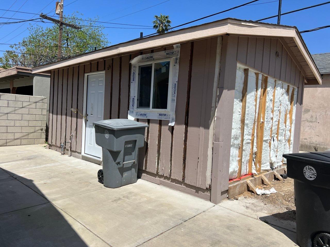New exterior door, window, and insulation during the garage-to-ADU conversion (during construction)