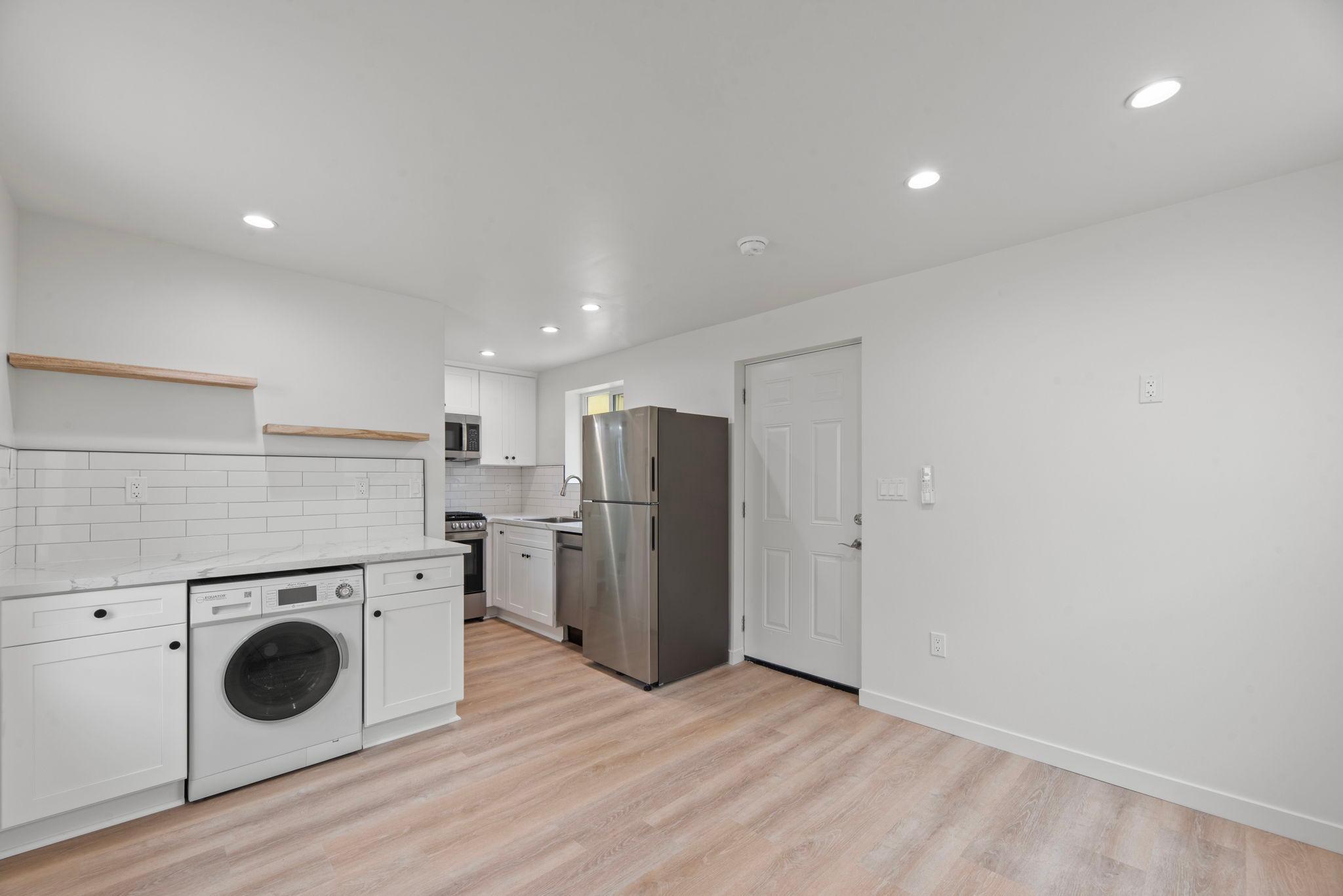 Kitchen with full-size refrigerator and in-unit laundry (after)