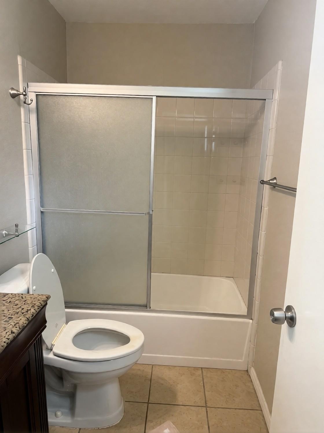Before: the old tub and shower with framed sliding doors