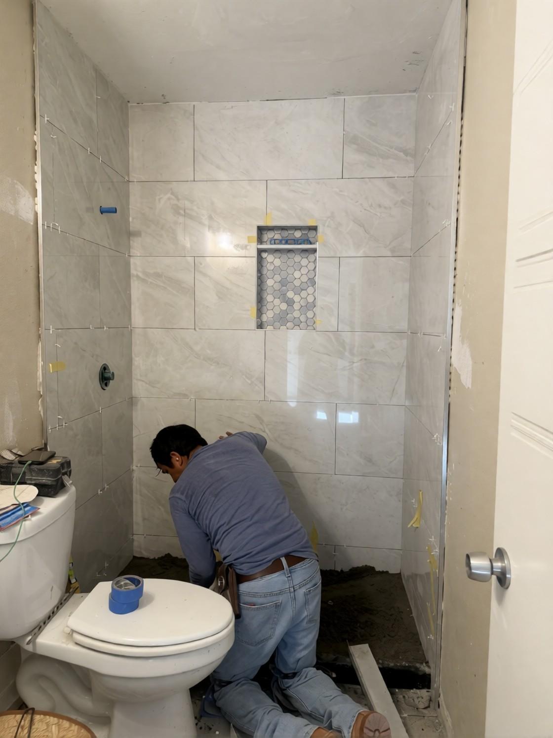 Crew setting the hex mosaic shower floor