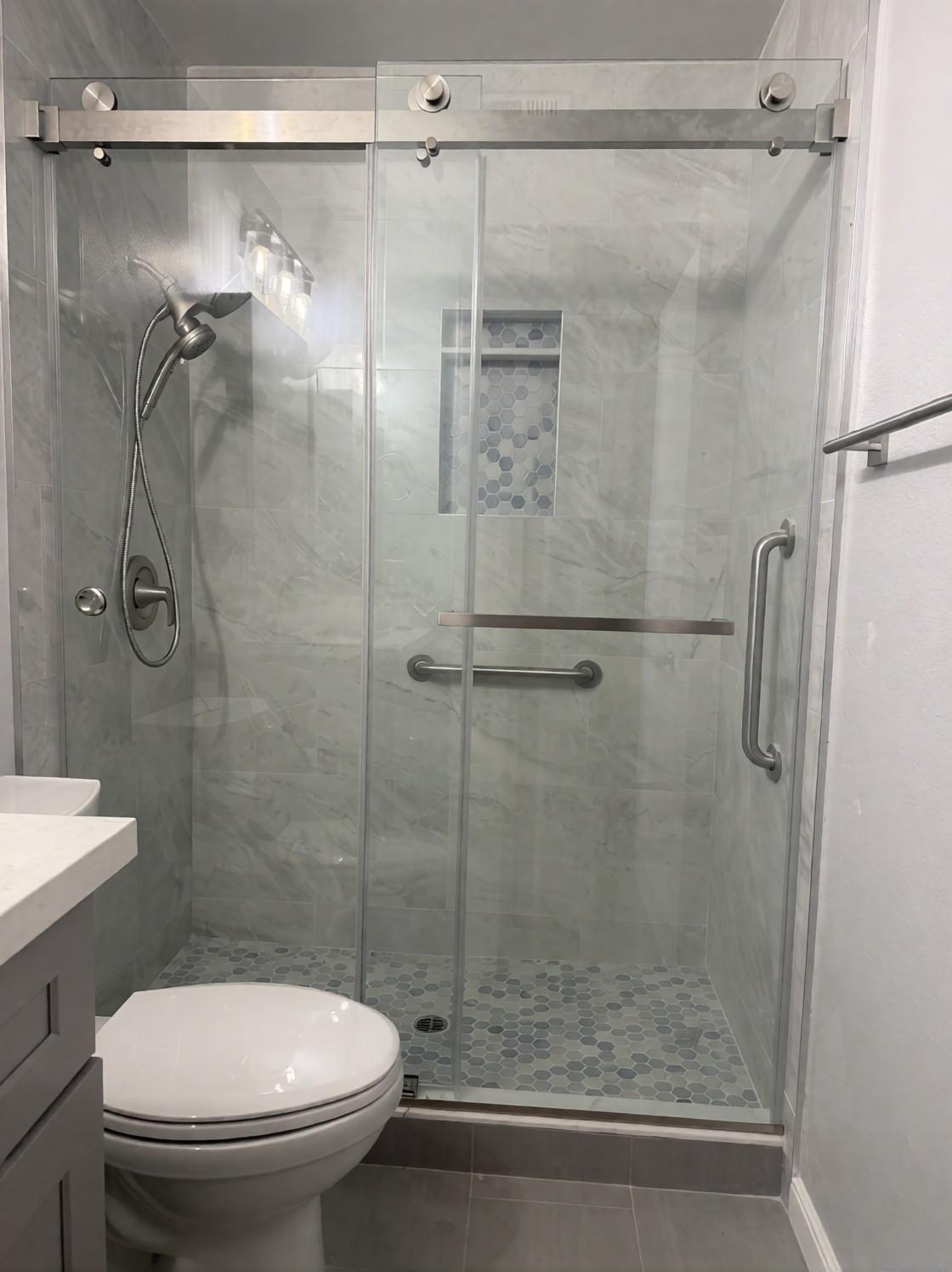Finished walk-in shower with a sliding glass door and grab bars, Santa Ana tub-to-shower conversion